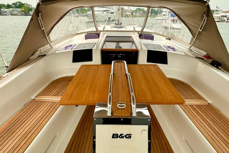 Slide: The Image of Interior view of a 2016 Hanse 415 sailboat with wooden table and seating. - 9