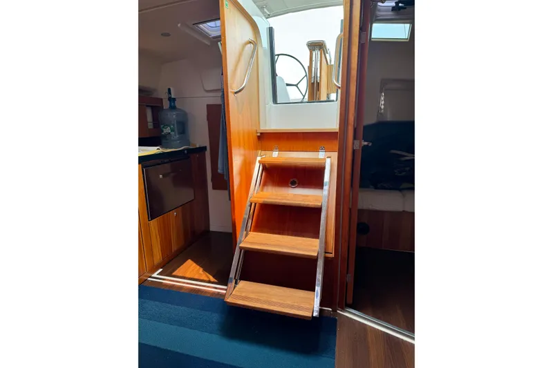 Slide: The Image of Interior of 2016 Hanse 415 yacht with wooden stairs and cabin view. - 18