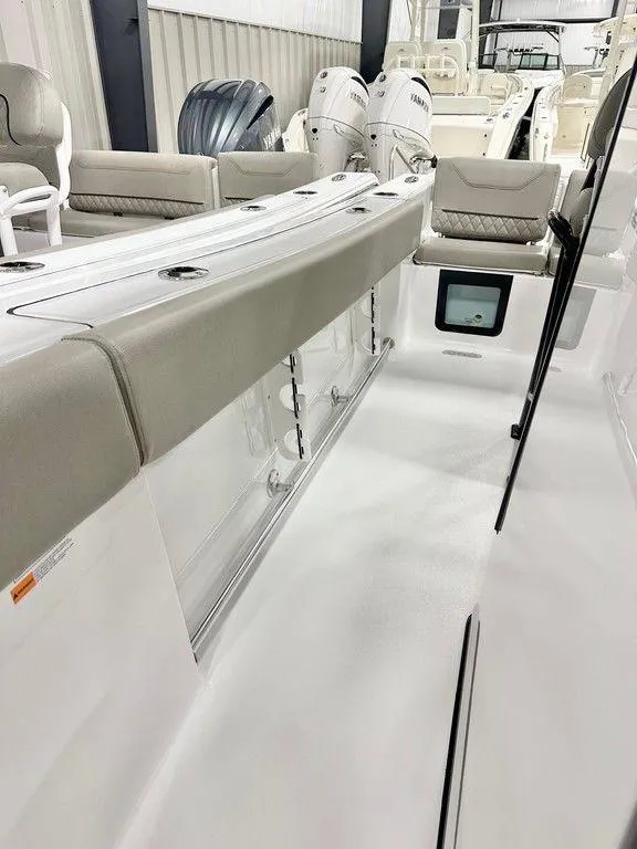 Slide: The Image of 2025 Sportsman Heritage 231 boat interior with cushioned seating and storage compartments. - 6