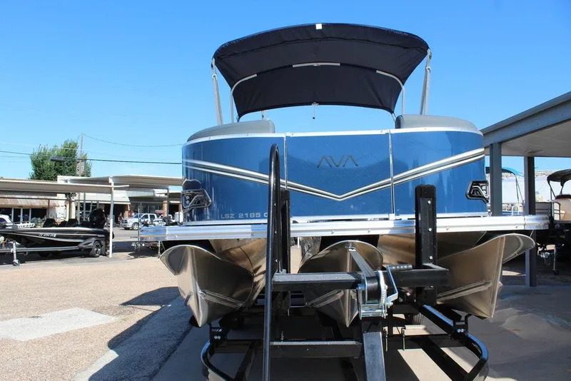 Slide: The Image of 2025 Avalon LSZ Quad Lounger Shift 21 FT pontoon boat on trailer, blue exterior. - 11
