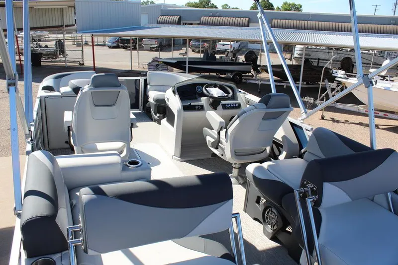Slide: The Image of 2025 Avalon LSZ Quad Lounger Shift 21 FT pontoon boat interior with modern seating and helm. - 21