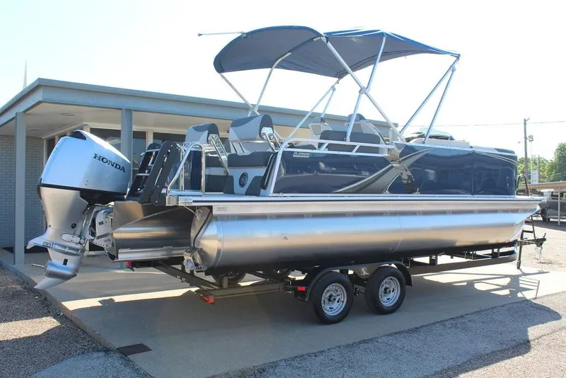 Slide: The Image of 2025 Avalon LSZ Quad Lounger Shift 21 FT pontoon boat with Honda outboard motor on trailer. - 3
