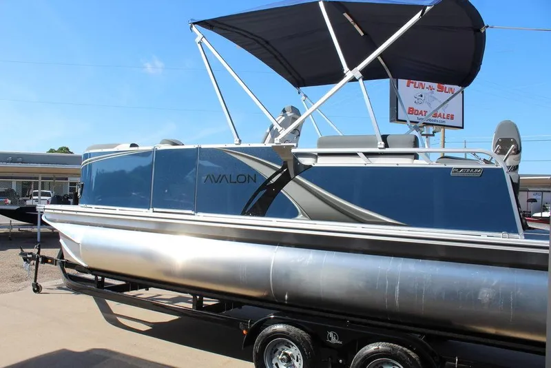 Slide: The Image of 2025 Avalon LSZ Quad Lounger Shift 21 FT pontoon boat with canopy at dealership. - 4