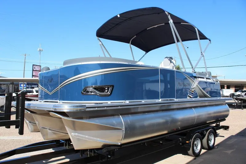 Slide: The Image of 2025 Avalon LSZ Quad Lounger Shift 21 FT pontoon boat with blue exterior and canopy. - 6