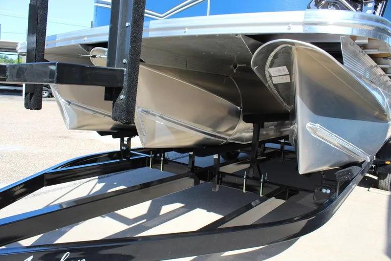 Slide: The Image of 2025 Avalon LSZ Quad Lounger Shift 21 FT pontoon boat on trailer, close-up view. - 8