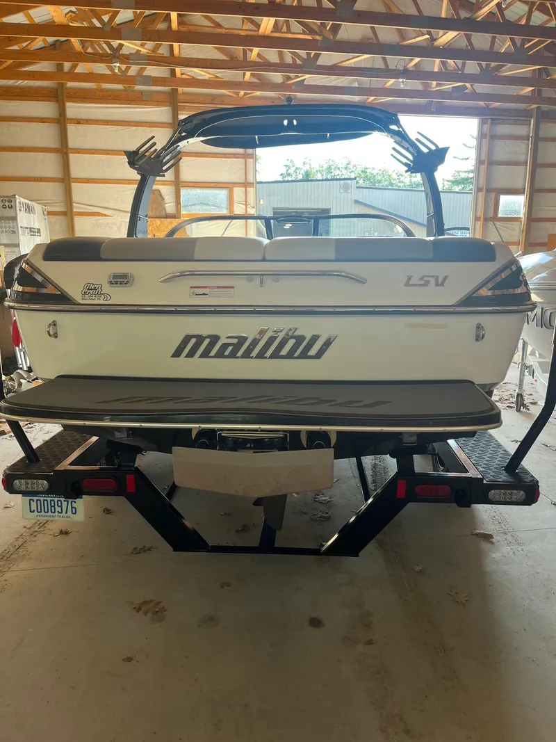 Slide: The Image of 2008 Malibu Sunscape 21 LSV boat in a garage, rear view with trailer. - 10