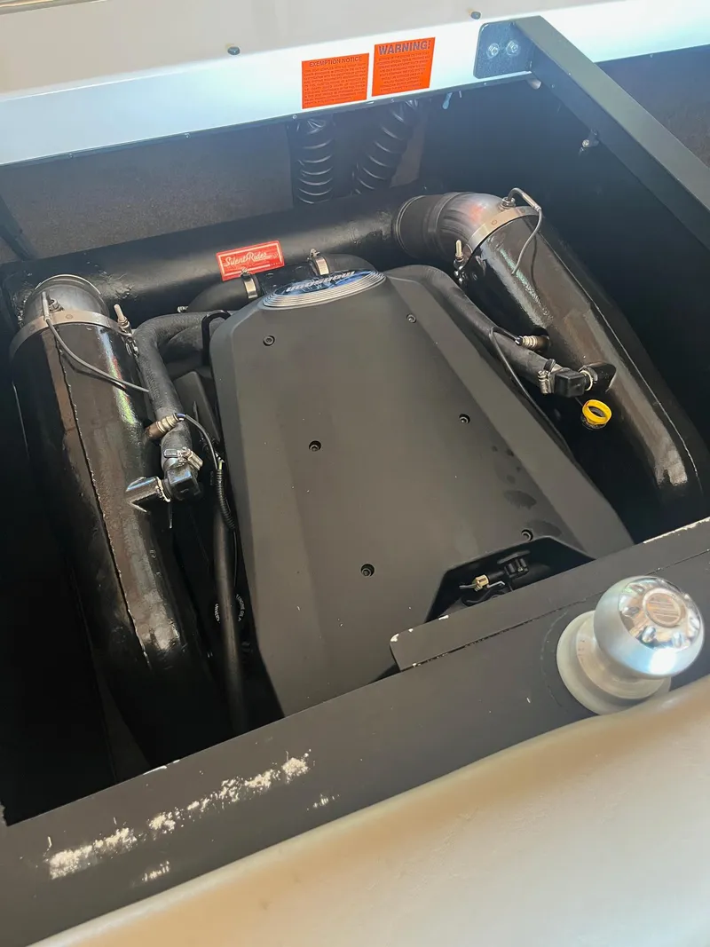 Slide: The Image of Engine compartment of a 2008 Malibu Sunscape 21 LSV boat, showcasing mechanical components. - 2