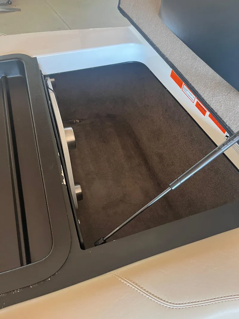 Slide: The Image of Open storage compartment in 2008 Malibu Sunscape 21 LSV boat. - 3