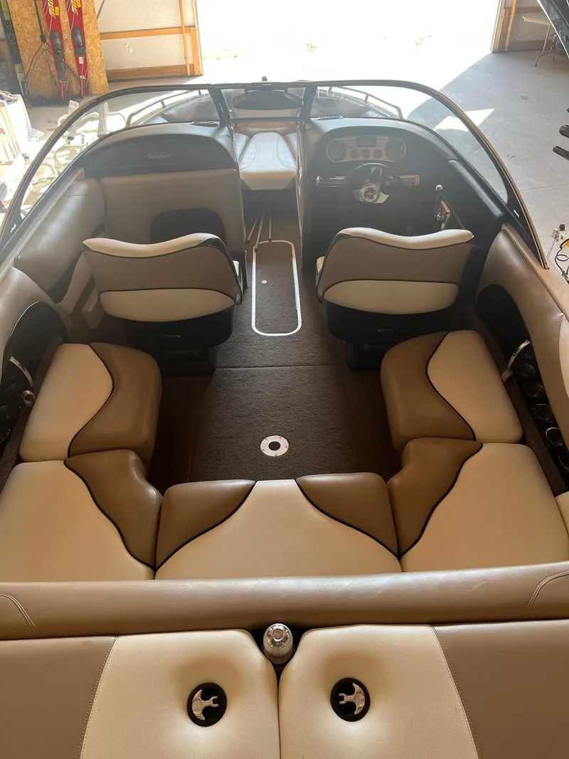 Slide: The Image of 2008 Malibu Sunscape 21 LSV boat interior with beige seating and steering console. - 4