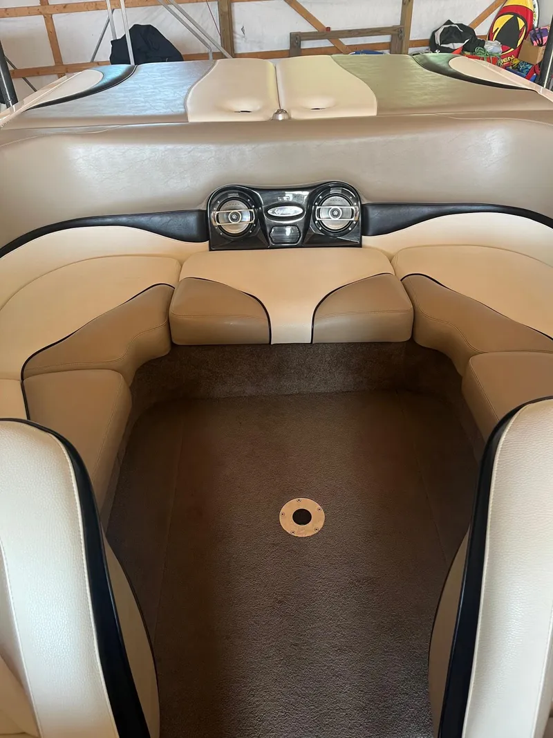 Slide: The Image of 2008 Malibu Sunscape 21 LSV boat interior with beige seating and carpeted floor. - 5