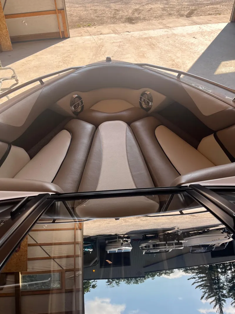 Slide: The Image of 2008 Malibu Sunscape 21 LSV boat interior with cushioned seating and speakers. - 6