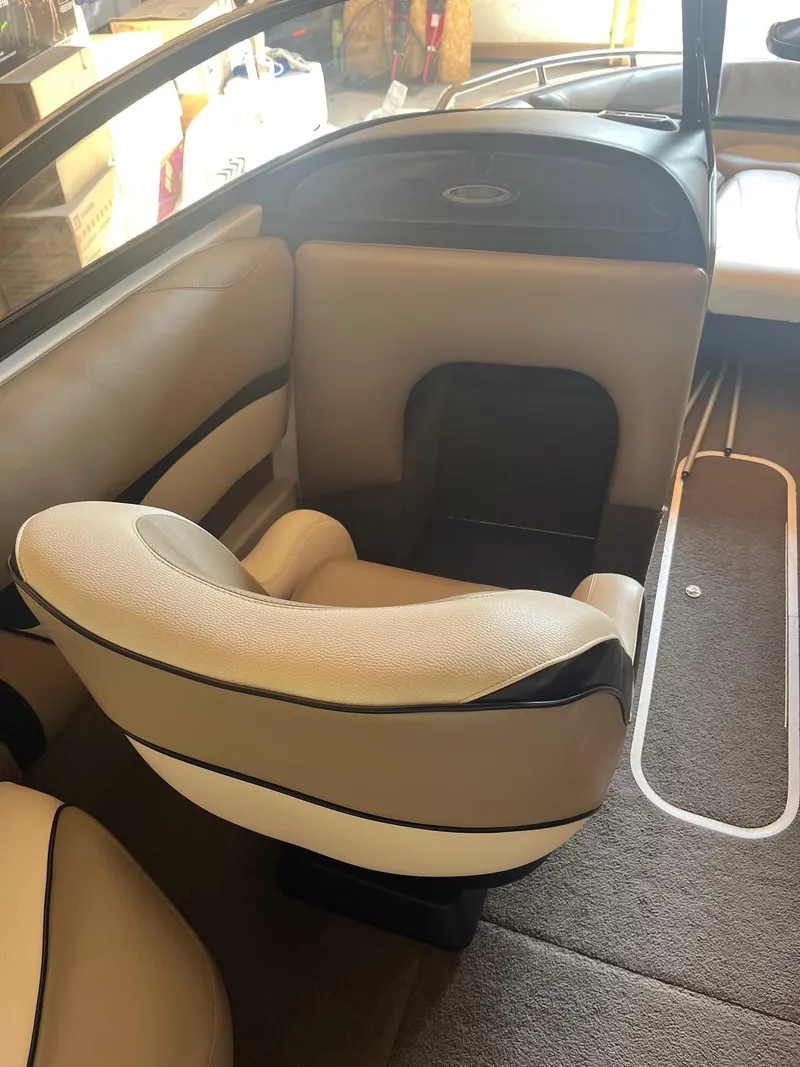 Slide: The Image of 2008 Malibu Sunscape 21 LSV boat interior with beige seating and carpeted flooring. - 7