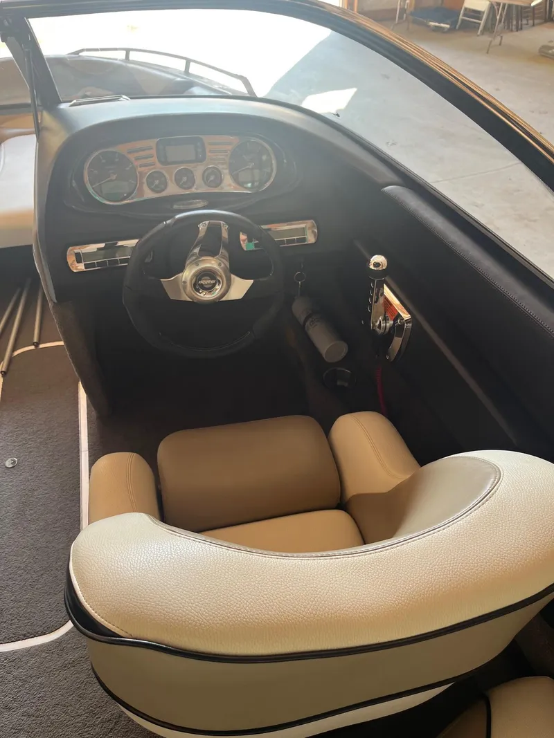 Slide: The Image of 2008 Malibu Sunscape 21 LSV boat interior with steering wheel and dashboard controls. - 8