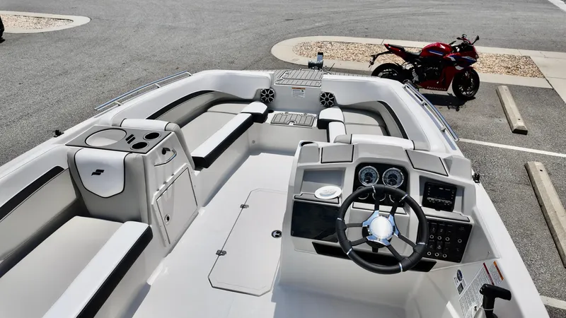 Slide: The Image of 2026 Starcraft SVX 191 OB boat interior with steering wheel, dashboard, and seating. - 7