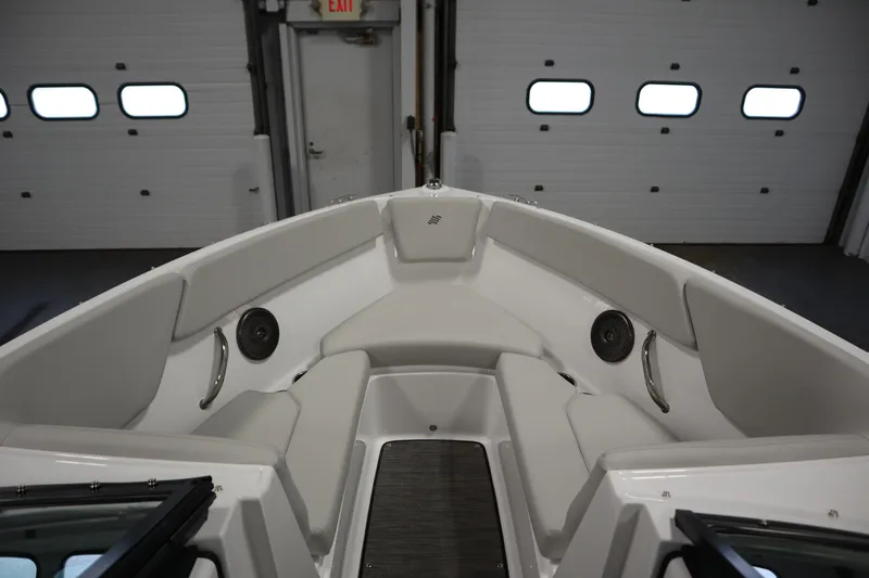 Slide: The Image of 2025 Four Winns H1 Freedom boat interior with cushioned seating and speakers. - 11