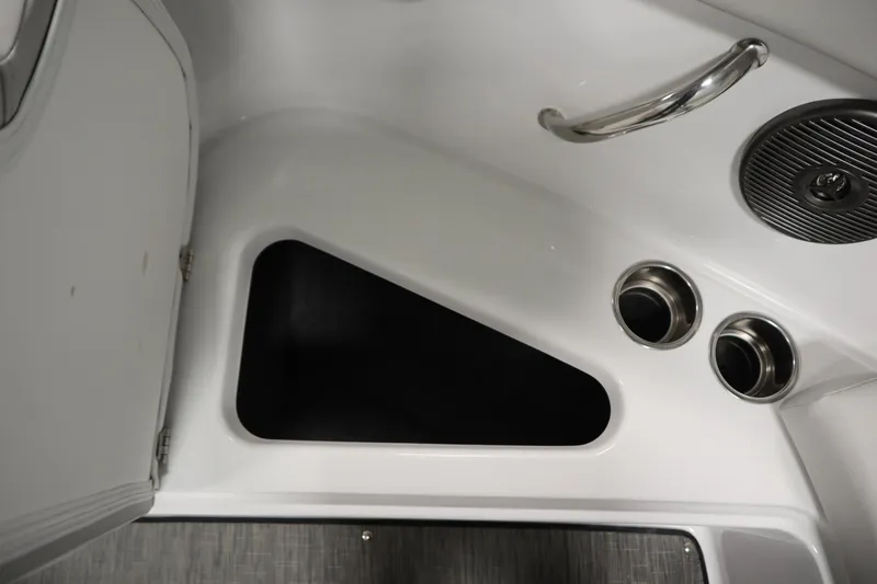 Slide: The Image of 2025 Four Winns H1 Freedom boat interior with storage compartment and cup holders. - 15