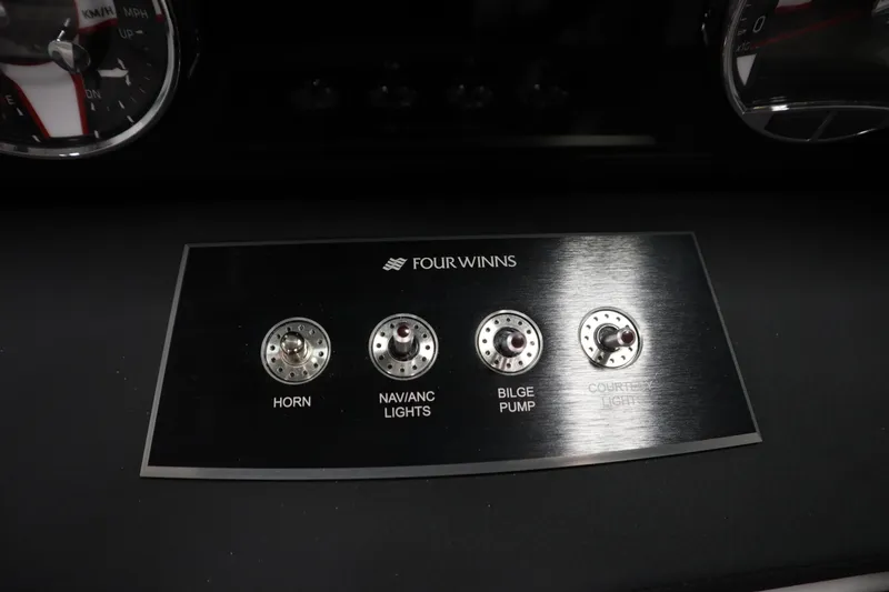 Slide: The Image of Control panel of 2025 Four Winns H1 Freedom boat with switches for horn, lights, and bilge pump. - 22