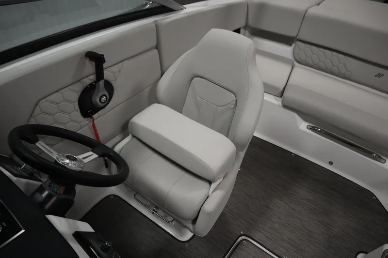 Slide: The Image of 2025 Four Winns H1 Freedom boat interior with gray seating and steering wheel. - 28