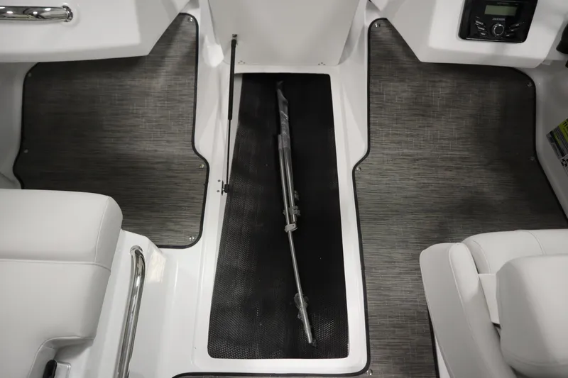 Slide: The Image of Interior of 2025 Four Winns H1 Freedom boat, featuring sleek seating and flooring. - 30