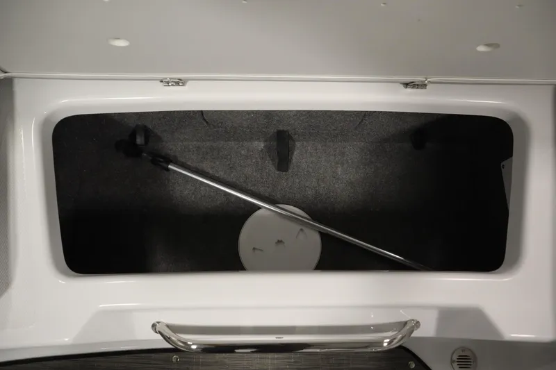Slide: The Image of 2025 Four Winns H1 Freedom storage compartment with a metal handle and dark interior. - 40