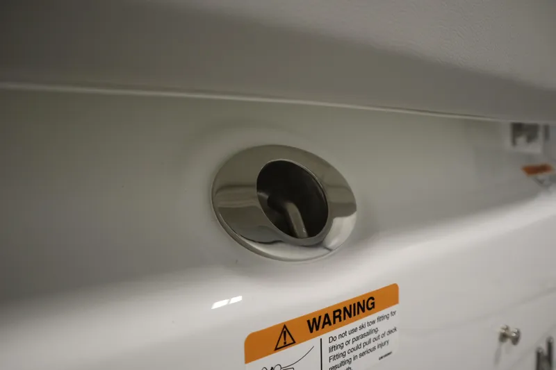 Slide: The Image of Close-up of 2025 Four Winns H1 Freedom boat detail with warning label. - 48