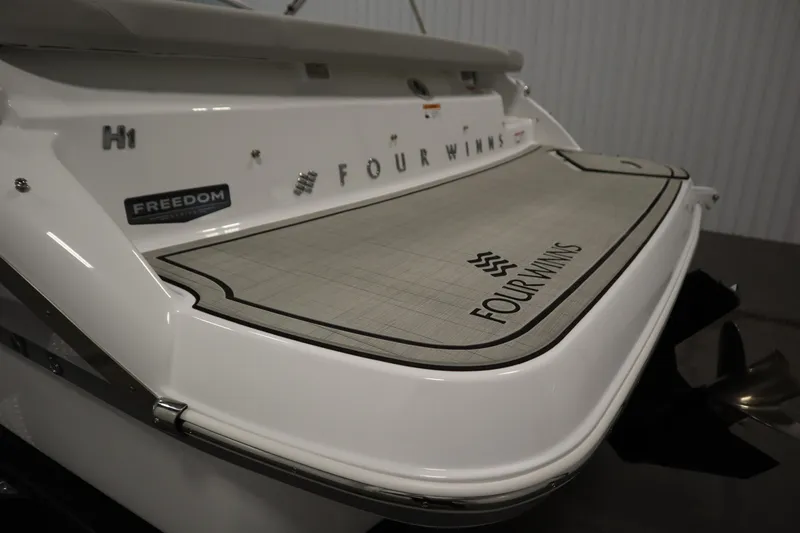 Slide: The Image of 2025 Four Winns H1 Freedom boat stern with branded swim platform. - 49