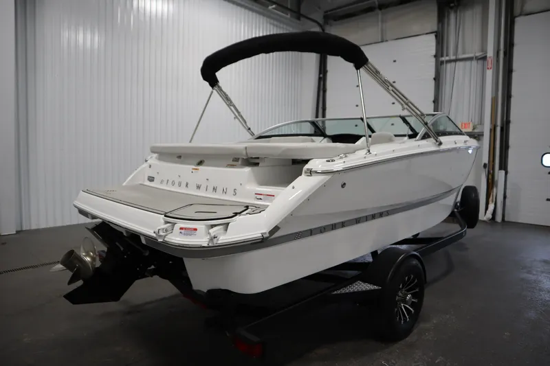 Slide: The Image of 2025 Four Winns H1 Freedom boat on trailer in indoor storage. - 5