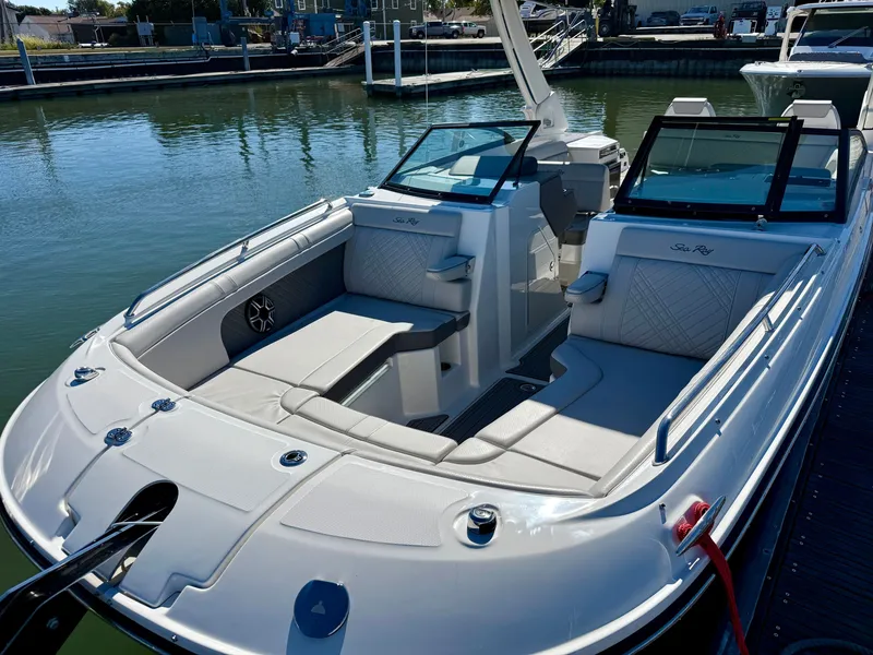 Slide: The Image of The image shows a 2026 Sea Ray SDX 290 boat docked. It features a sleek, modern interior with comfortable seating and an open deck. - 16