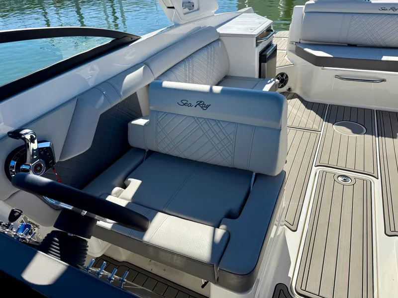Slide: The Image of The image shows the cockpit of a 2026 Sea Ray SDX 290 with sleek gray upholstery. - 11