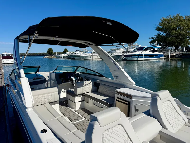 Slide: The Image of The image shows a 2026 Sea Ray SDX 290 boat with sleek seating and a black sunshade. - 4