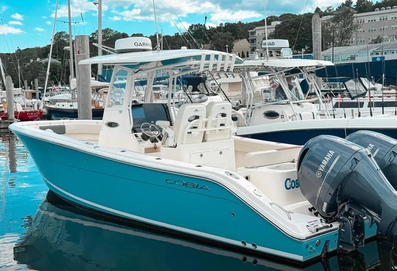 The Image of 2023 Cobia 280 Center Console boat docked with Yamaha engines. - 0
