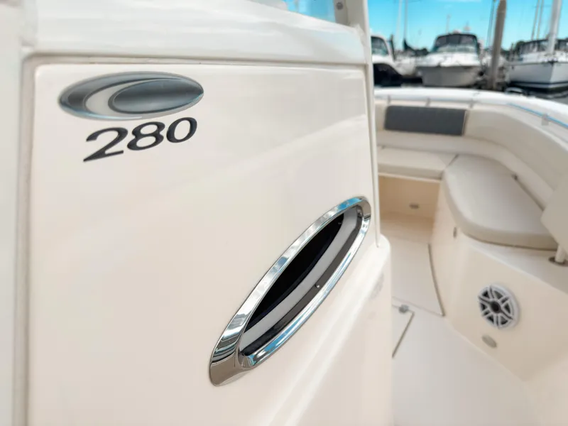 Slide: The Image of 2023 Cobia 280 Center Console boat interior with seating and logo detail. - 1