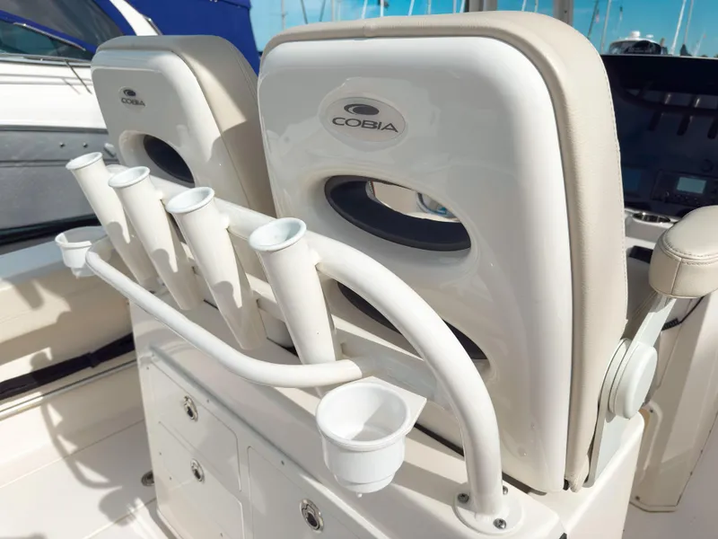 Slide: The Image of 2023 Cobia 280 Center Console boat interior with rod holders and seating. - 14