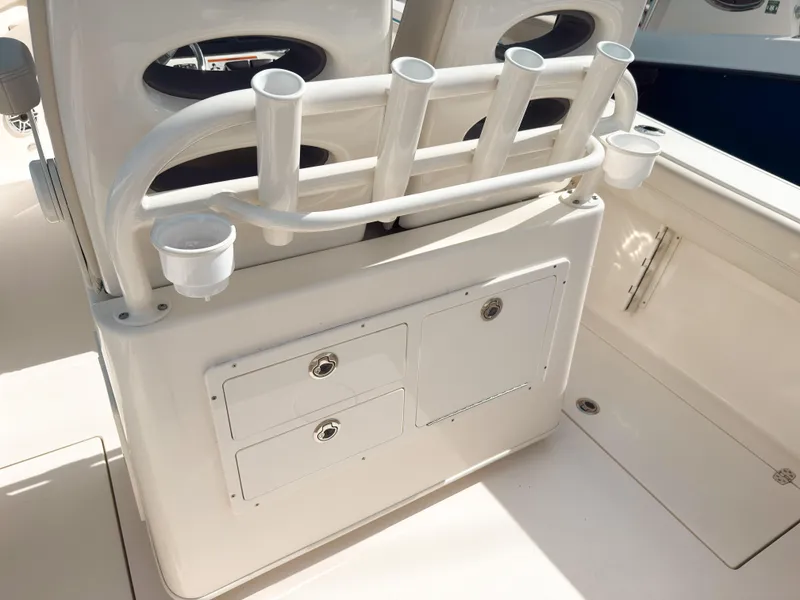 Slide: The Image of 2023 Cobia 280 Center Console boat interior with rod holders and storage compartments. - 15