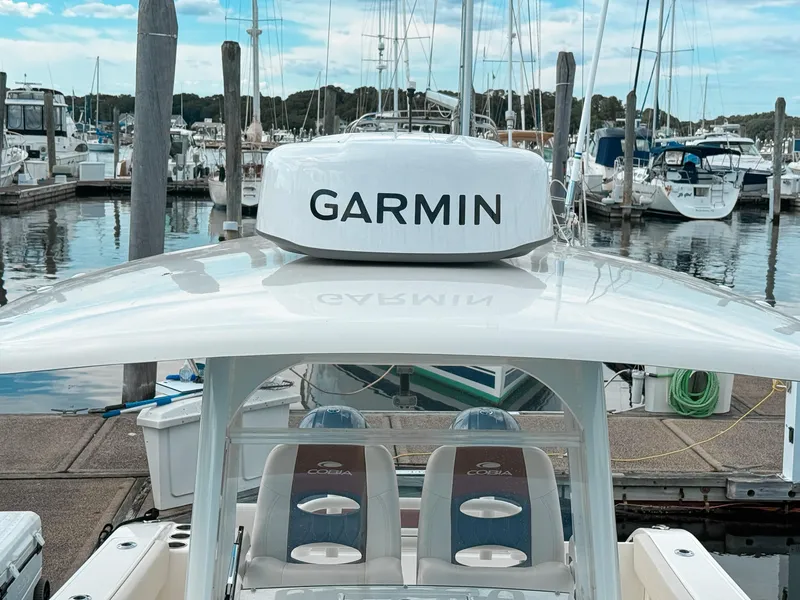 Slide: The Image of 2023 Cobia 280 Center Console boat with Garmin equipment at marina. - 26
