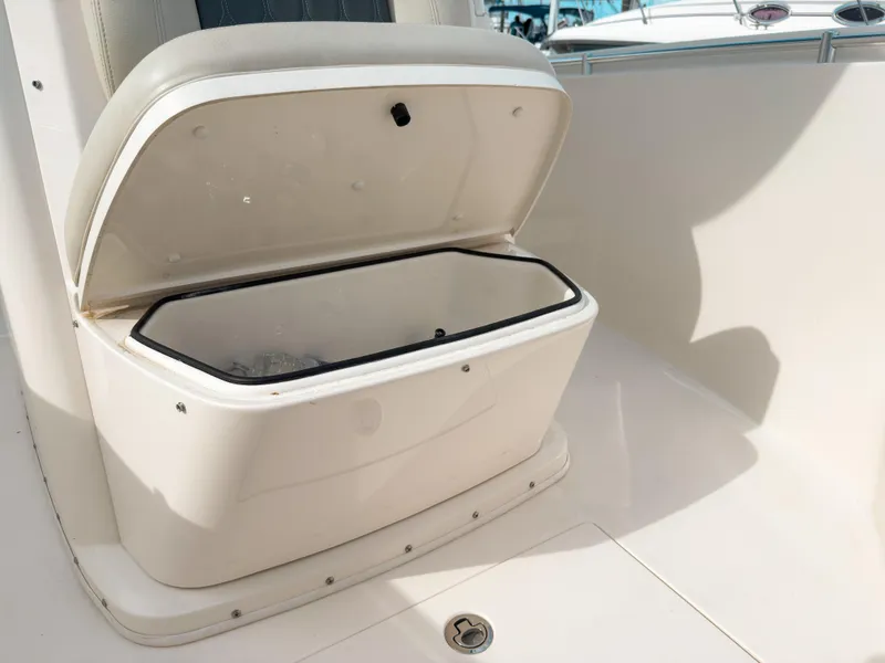 Slide: The Image of Open storage compartment on 2023 Cobia 280 Center Console boat. - 28
