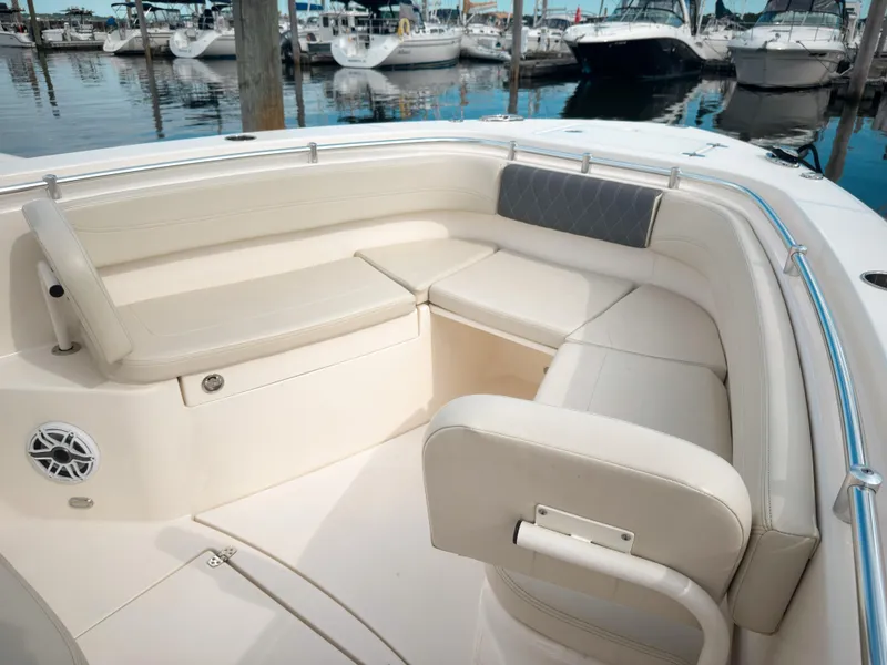 Slide: The Image of 2023 Cobia 280 Center Console boat with spacious seating at marina. - 29
