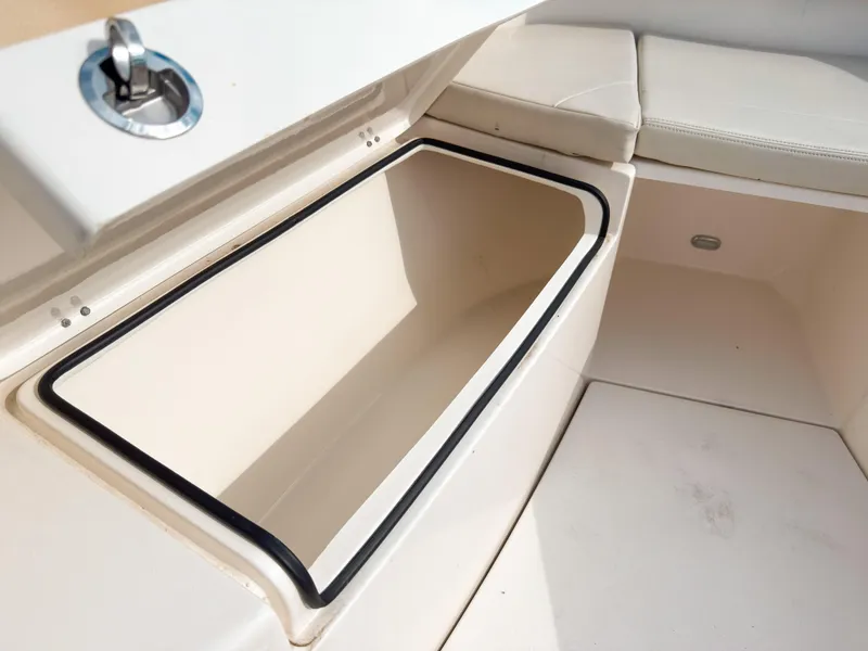 Slide: The Image of 2023 Cobia 280 Center Console storage compartment with cushioned seating. - 35