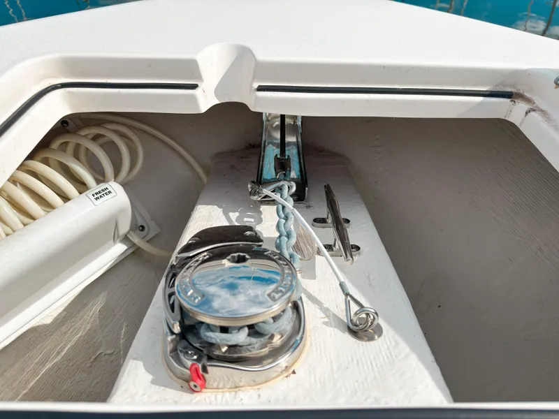 Slide: The Image of 2023 Cobia 280 Center Console anchor locker with chain and fresh water hose. - 38