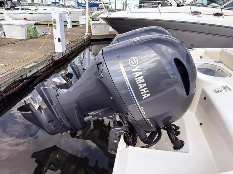 Slide: The Image of 2023 Cobia 280 Center Console with Yamaha outboard engines at marina dock. - 4