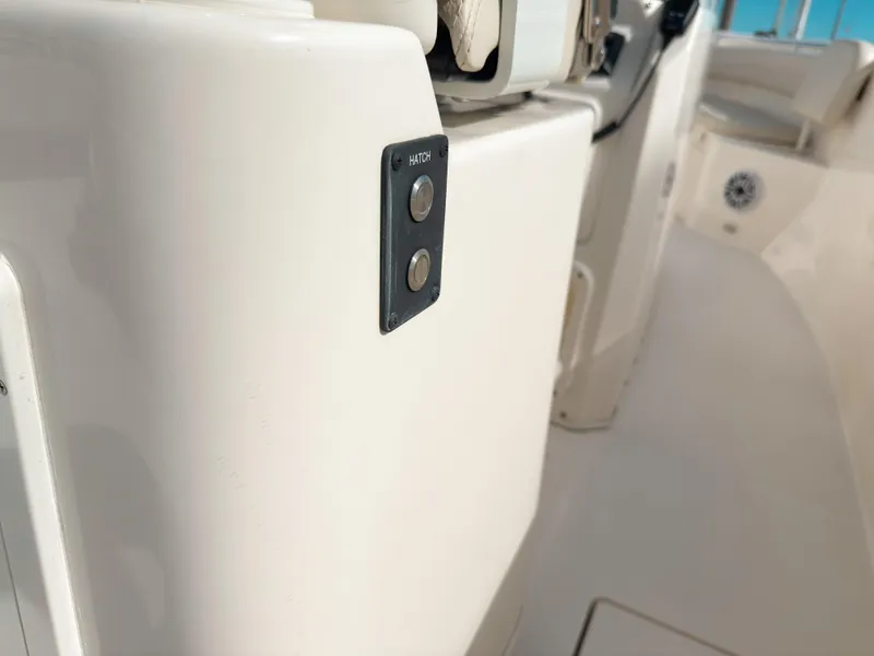 Slide: The Image of 2023 Cobia 280 Center Console boat interior with hatch button detail. - 47