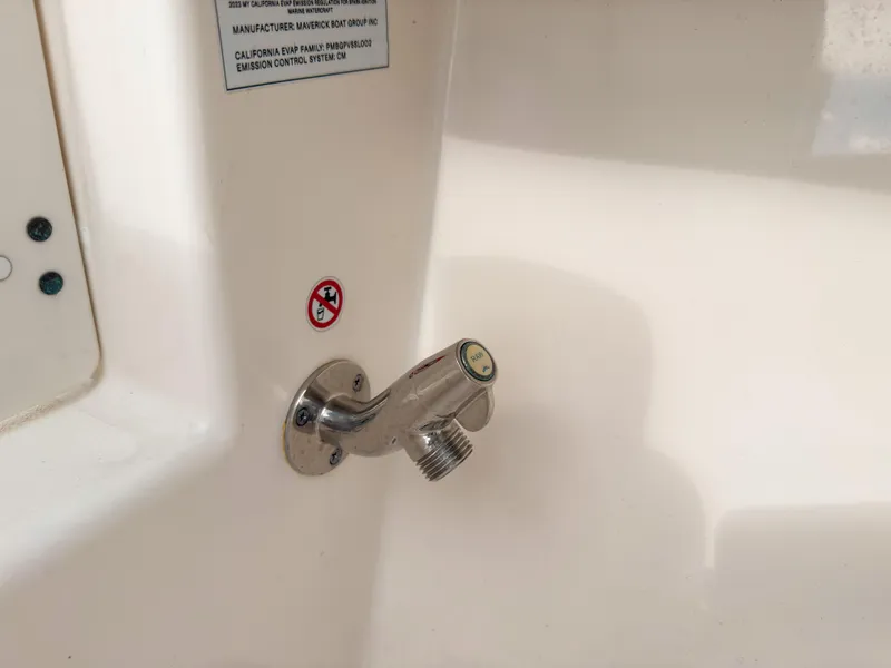 Slide: The Image of Stainless steel faucet on 2023 Cobia 280 Center Console boat interior. - 48