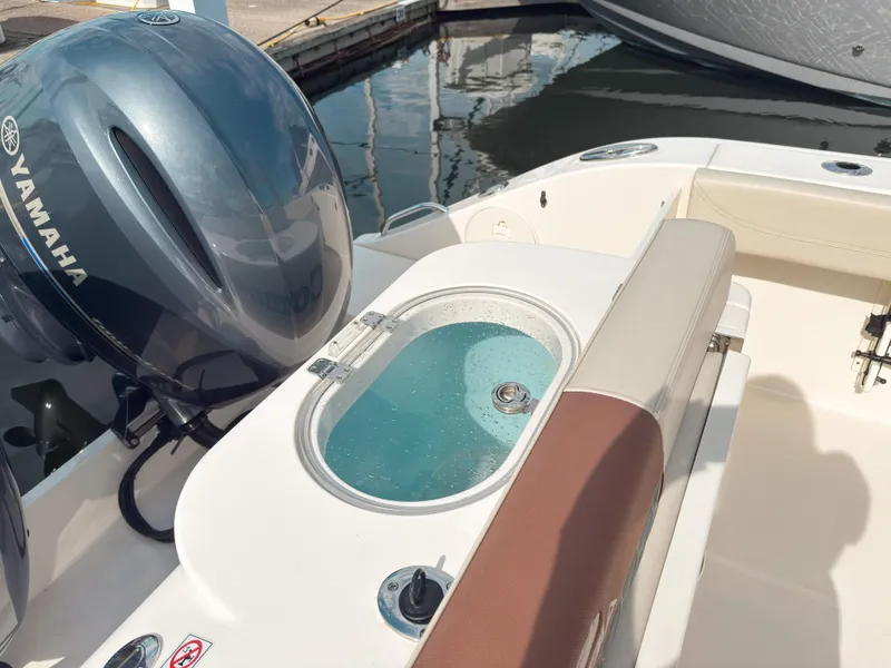 Slide: The Image of 2023 Cobia 280 Center Console boat with Yamaha engine and livewell at dock. - 7