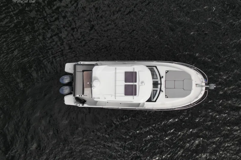 Slide: The Image of Overhead view of 2024 Jeanneau NC 1095 boat on dark water. - 10