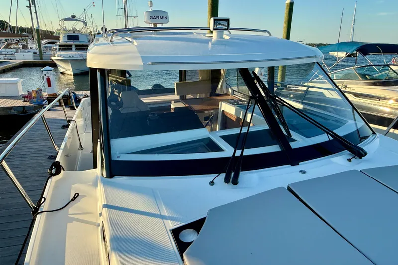 Slide: The Image of 2024 Jeanneau NC 1095 boat docked at marina, showcasing sleek design and modern features. - 15