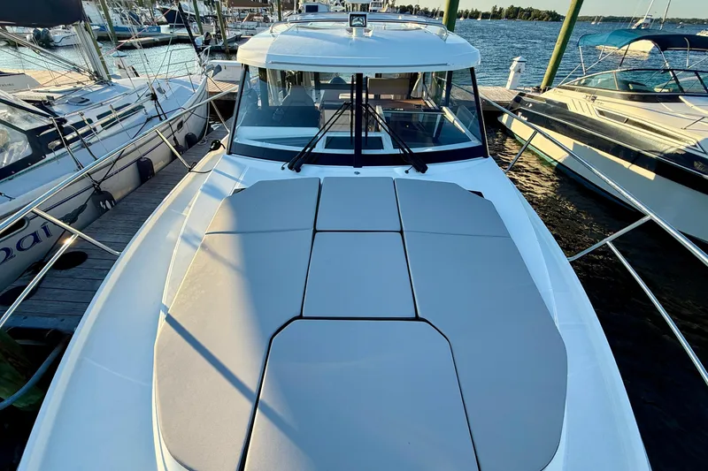 Slide: The Image of 2024 Jeanneau NC 1095 boat docked, featuring spacious deck and sleek design. - 16