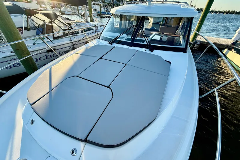 Slide: The Image of 2024 Jeanneau NC 1095 boat with sunpad, docked at marina. - 17