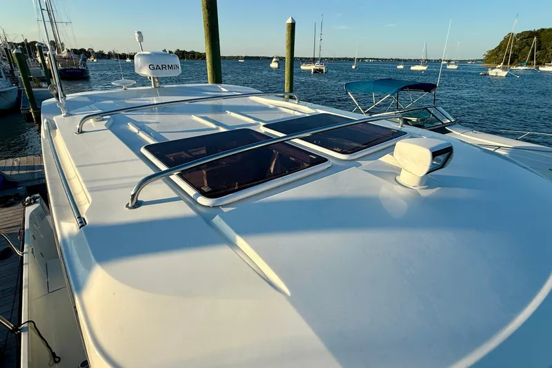 Slide: The Image of 2024 Jeanneau NC 1095 boat roof with Garmin equipment, docked by the water. - 19