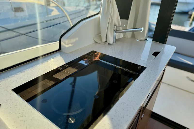 Slide: The Image of 2024 Jeanneau NC 1095 yacht kitchen with sleek countertop and modern faucet. - 33