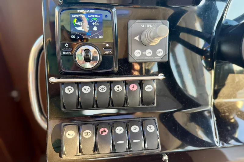 Slide: The Image of Control panel of 2024 Jeanneau NC 1095 boat with switches and Zipwake system. - 36